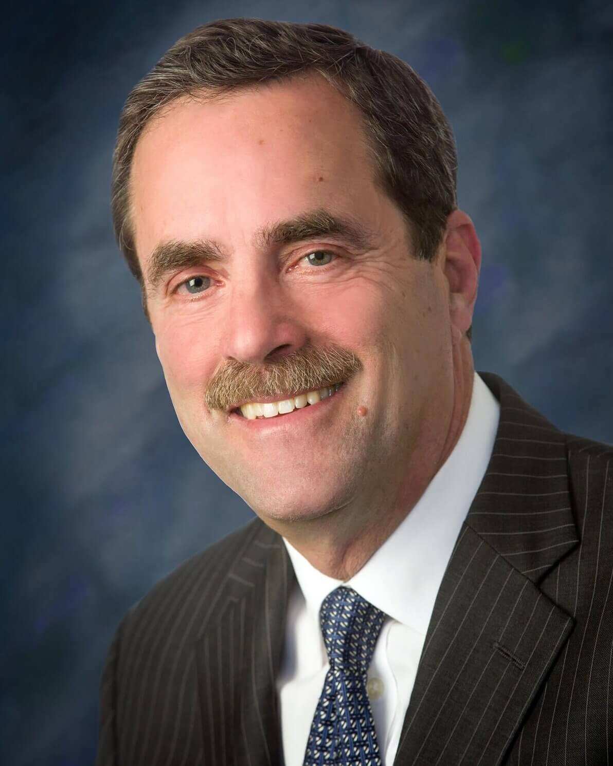 Michael W. Emerson, Esq. Hearing officer for National Arbitration and Mediation, with name written below photo